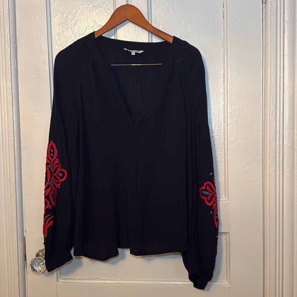 cute blouse with intricate design on the sleeves in great condition